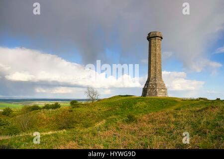 Portesham, Dorset, UK.  26th April 2017.  UK Weather.  Sunshine at Hardy Monument near Portesham in Dorset with a dark shower cloud overhead.  Hardy's Monument comemorates Vice Admiral Sir Thomas Masterman Hardy who was Flag Captain under Nelson aboard HMS Victory at the battle of Trafalgar.  Hardy lived in the nearby village of Portesham.  The monument is owned by the National Trust.  Photo Credit: Graham Hunt/Alamy Live News Stock Photo