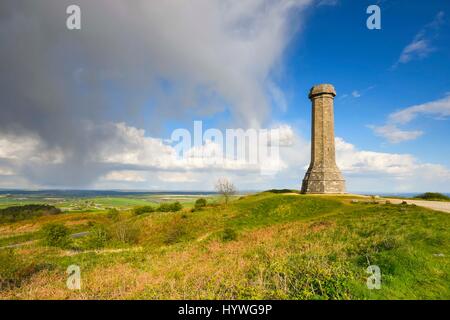 Portesham, Dorset, UK.  26th April 2017.  UK Weather.  Sunshine at Hardy Monument near Portesham in Dorset with a dark shower cloud approaching.  Hardy's Monument comemorates Vice Admiral Sir Thomas Masterman Hardy who was Flag Captain under Nelson aboard HMS Victory at the battle of Trafalgar.  Hardy lived in the nearby village of Portesham.  The monument is owned by the National Trust.  Photo Credit: Graham Hunt/Alamy Live News Stock Photo