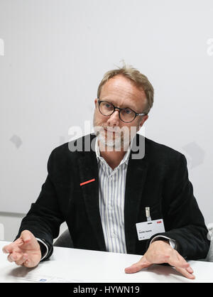Hanover, Germany. 24th Apr, 2017. ABB Group's chief digital officer Guido Jouret speaks during an interview with Xinhua News Agency at the Hanover Messe 2017 in Hanover, Germany, on April 24, 2017. The combination of better cameras, better sensors and machine learning will lead to more extensive application of robots in production, said ABB Group's chief digital officer Guido Jouret in an interview with Xinhua at the Hanover Fair. Credit: Shan Yuqi/Xinhua/Alamy Live News Stock Photo