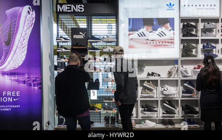 JD Sports store. UK. Adidas, Nike and Puma trainers/running shoes display Stock Photo