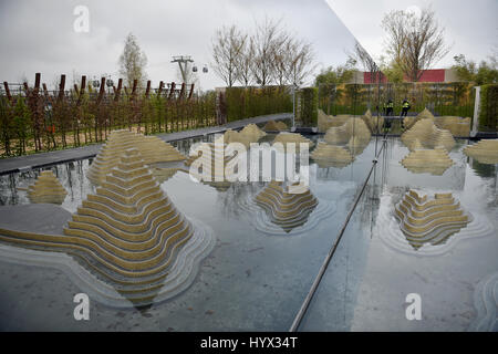 Berlin, Germany. 7th Apr, 2017. The cable car is reflected in the themed garden, the 'Garden of the Mind', in the grounds of the International Garden Exhibition 'IGA 2017' in Berlin, Germany, 7 April 2017. It is the largest garden festival in Germany. It takes place every year in a different town, and opens 13 April 2017. Photo: Britta Pedersen/dpa-Zentralbild/dpa/Alamy Live News Stock Photo