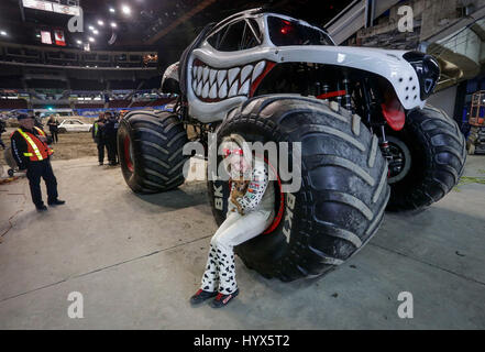 Vancouver, Canada. 7th Apr, 2017. The first female Canadian monster truck driver Cynthia Gauthier sits on the wheel of her vehicle on the race track during the Monster Jam show at Pacific Coliseum in Vancouver, Canada, April 7, 2017. Credit: Liang Sen/Xinhua/Alamy Live News Stock Photo