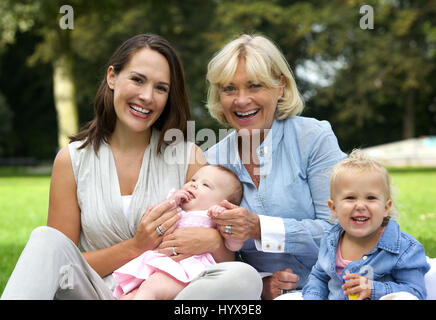 Portrait of a happy family with mother, children and grandmother outdoors Stock Photo