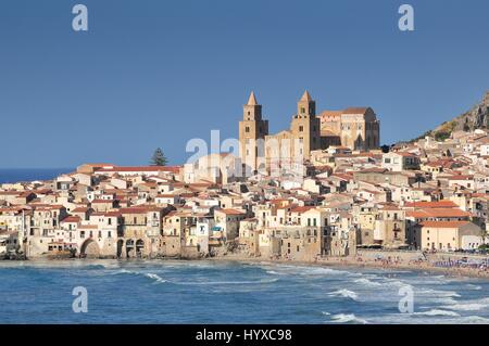 Houses along the shoreline and cathedral in background Cefalu Sicily. Stock Photo