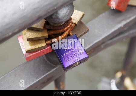 Love locks on a bridge in Hamburg, Germany. The lock was placed on the bridge in 2013. Stock Photo