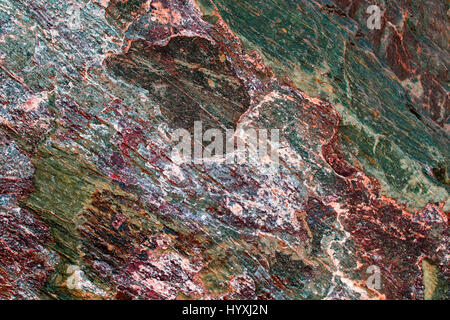 natural marble background with a rough texture of stone with different colored patches and cracks Stock Photo