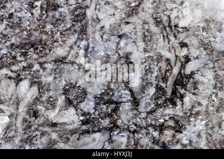 the natural rough texture of stone with shiny glass inclusions Stock Photo