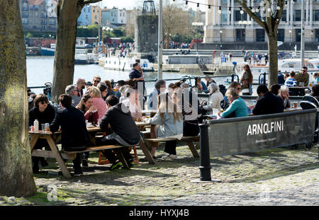 People sat eating and drinking at tables outside the Arnolfini, Bristol, UK Stock Photo