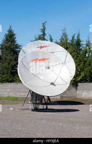 EUGENE, OR - MARCH 31, 2017: Communcations dish for cable television at a media facility that has been abandoned. Stock Photo