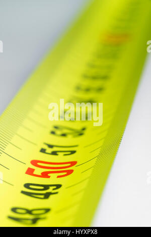 Yellow metal industrial tape measure with standardized metric system such as used in Europe. Stock Photo