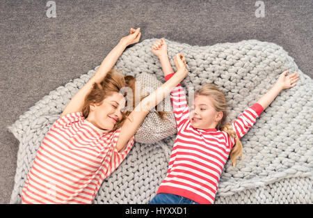 Top view of mother and daughter waking up and stretching themselves Stock Photo