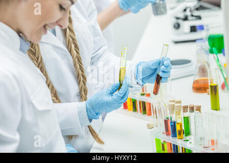 Young female scientists working with reagents in chemical laboratory Stock Photo