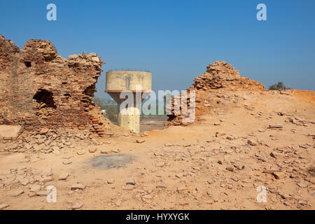 bhatner fort walls in need of restoration work with a water tower in hanumangarh rajasthan india under a blue sky Stock Photo