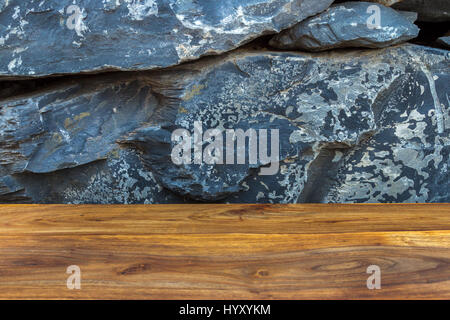 Vintage reddish brown wood with exotic natural stone wall as background Stock Photo