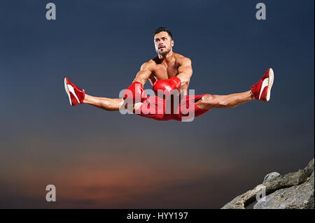 Horizontal shot of a young handsome muscular sportsman doing splits in the air jumping high copyspace gymnast physique sport athletics active lifestyl Stock Photo