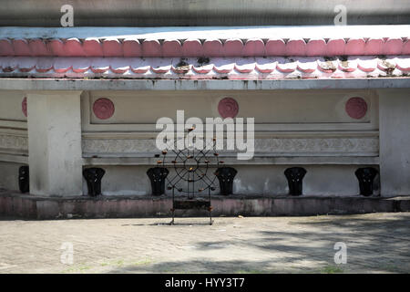 Aluviharaya Rock Cave Temple Sri Lanka Matale District Kandy-Dambulla Highway Butter Lamps In Dharma Wheel Frame In Front Of Dagoba Stock Photo