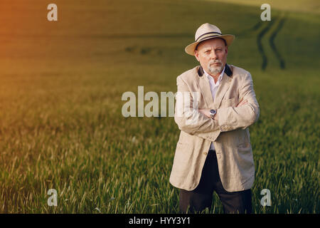 old man in field Stock Photo