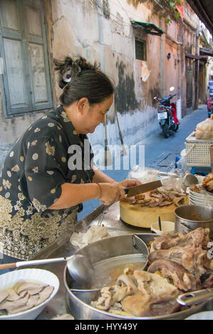Outdoor food stand in an alley in Bangkok, Thailand Stock Photo