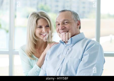 Senior man and mature woman smiling towards camera. Stock Photo