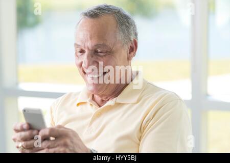 Senior man using cell phone. Stock Photo