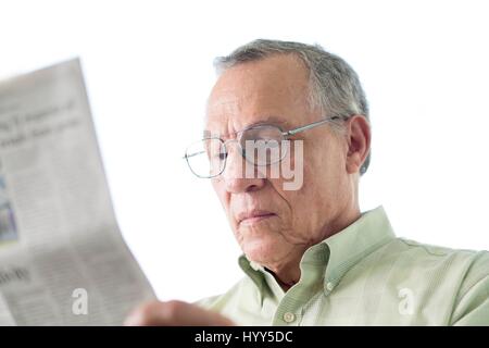 Senior man reading newspaper. Stock Photo