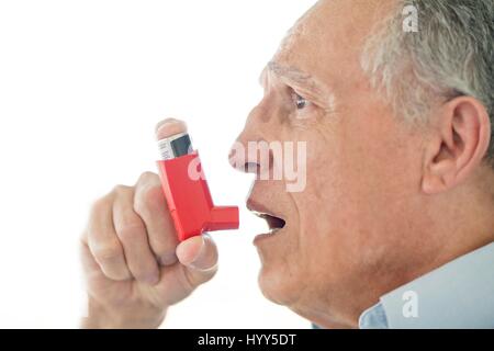 Senior man using inhaler. Stock Photo