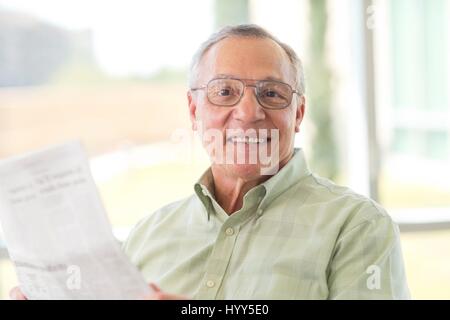 Senior man reading newspaper. Stock Photo