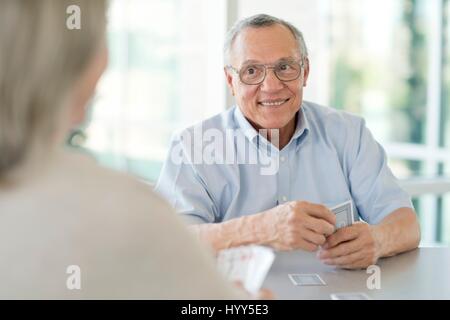 Senior couple playing cards. Stock Photo