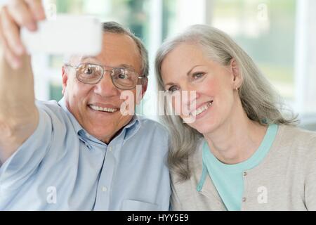 Portrait of senior couple taking selfie on phone. Stock Photo