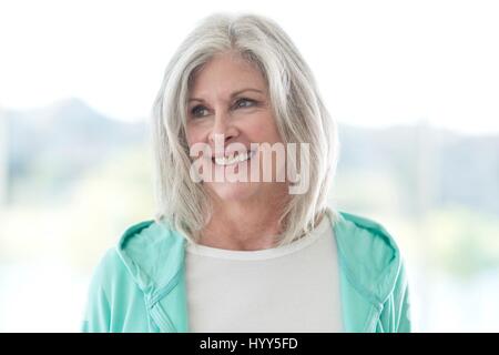 Senior woman smiling and looking away. Stock Photo