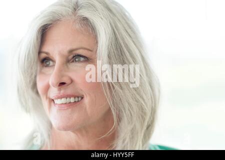 Senior woman smiling and looking away. Stock Photo