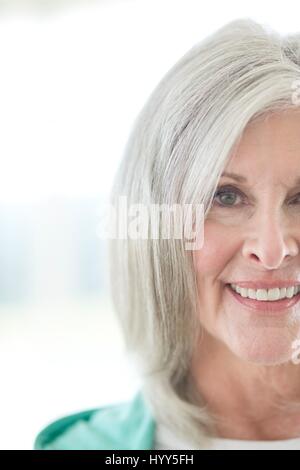 Senior woman smiling and looking at camera. Stock Photo