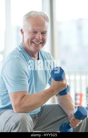 Senior man using hand weights. Stock Photo
