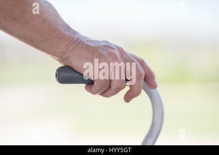 Senior man using walking frame, close up. Stock Photo