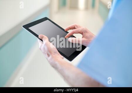 Surgeon using digital tablet, close up. Stock Photo