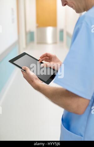 Surgeon using digital tablet, close up. Stock Photo