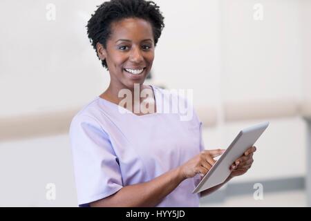 Female nurse using digital tablet. Stock Photo