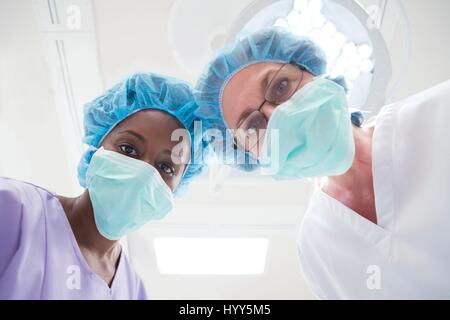 Two female surgeons looking towards camera, personal perspective. Stock Photo