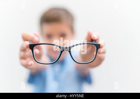 Boy holding glasses close up. Stock Photo