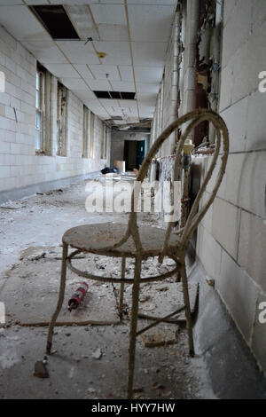 NEW JERSEY, USA: EERIE images and video have revealed the crumbling remains of an abandoned isolation hospital where children were allegedly abused and was the set for the hit Russel Crow movie A Beautiful Mind. The spooky pictures and footage show the contrasting conditions in the left wing and right wing of the old hospital building. The left wing, abandoned since the 1970s, is a flaking, dilapidated mess while the right wing, abandoned in more recent years, looks like it could still be active. Other haunting shots show the rusty padlocked doors, biohazard bags left behind and medical equipm Stock Photo