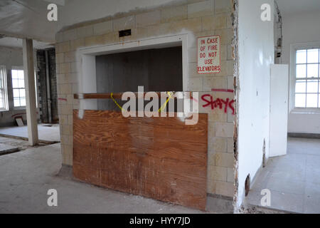 NEW JERSEY, USA: EERIE images and video have revealed the crumbling remains of an abandoned isolation hospital where children were allegedly abused and was the set for the hit Russel Crow movie A Beautiful Mind. The spooky pictures and footage show the contrasting conditions in the left wing and right wing of the old hospital building. The left wing, abandoned since the 1970s, is a flaking, dilapidated mess while the right wing, abandoned in more recent years, looks like it could still be active. Other haunting shots show the rusty padlocked doors, biohazard bags left behind and medical equipm Stock Photo