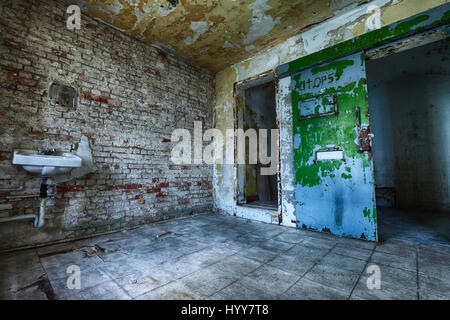CANADA: HAUNTING images have revealed the decaying remains of a 152-year-old Canadian prison that was built in 1865 to house notorious criminals. The eerie snaps show paint flaking from the walls and rust ridden cell doors that have been left flung open. Other shots show a dirty room with toilet facilities and graffiti carved into door frames. Another image shows light spraying through a cell onto the cracked stone floor. The spectacular snaps were taken at Winter Prison in Sherbrooke by photographer Keven Lavoie (34) from Montreal, Quebec, Canada. To take the pictures, Keven used a Canon 6D c Stock Photo