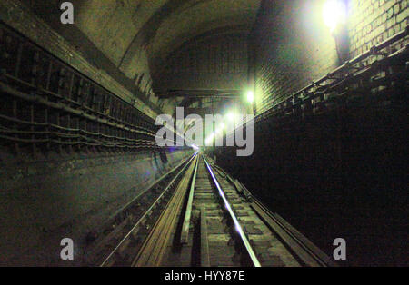 Brompton Road Underground station  E/B platform looking east. HAUNTING pictures have revealed the long-forgotten abandoned London Underground stations that lie deep below the city. The eerie images show the empty dusty Aldwych Underground station, which closed in 1994 and has been used as a film set for several high-profile productions including Sherlock, MR Selfridge and V for Vendetta. Other shots show other disused platforms and bricked up entrances to the former underground station including at Euston where the entrance closed in 1914 and the graffiti-clad Shoreditch station which closed i Stock Photo