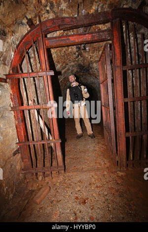 CALLINGTON, CORNWALL, UK: EERIE images reveal the Cornish mining tunnel that was once used to test explosives and research the potential impact of nuclear tests during the Cold War under the code name Operation Orpheus. The haunting pictures show inside the 2,180-foot tunnel where rusting sleepers and collapsing structures remain. Other shots, look down into an adit (entrance) and show the unsuspecting exterior of the mine where a metal gate has been closed across. The spectacular images were taken at the Excelsior Tunnel, Kit Hill, Callington, Cornwall by editor, Nat W (46) from London. To ta Stock Photo