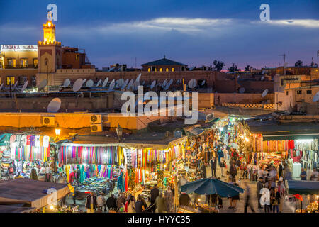 MARRAKECH, MOROCCO - APR 28, 2016: Tourists walking through the souks of the old medina of Marrakesh. Stock Photo