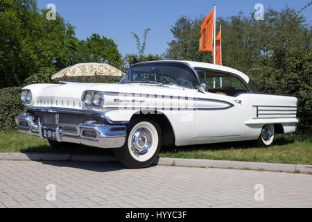 ROSMALEN, THE NETHERLANDS - MAY 8, 2016: Side view of a parked 1958 Oldsmobile Eighty Eight classic car. Stock Photo