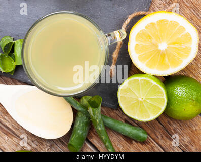 Drink with aloe vera and lemons. Glass cups on a slate tray from above. Stock Photo