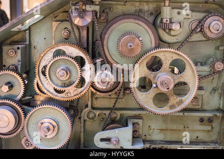 Cogs and gears inside of a vintage textile machine used to produce wool and silk products. Stock Photo