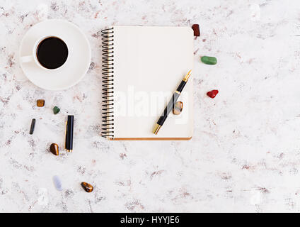 Flat lay, top view office table desk. Desk workspace with diary, pen, cup of coffee on white background. Stock Photo