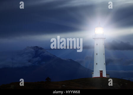 Cape Egmont Lighthouse and Taranaki Mount on background, New Zealand Stock Photo